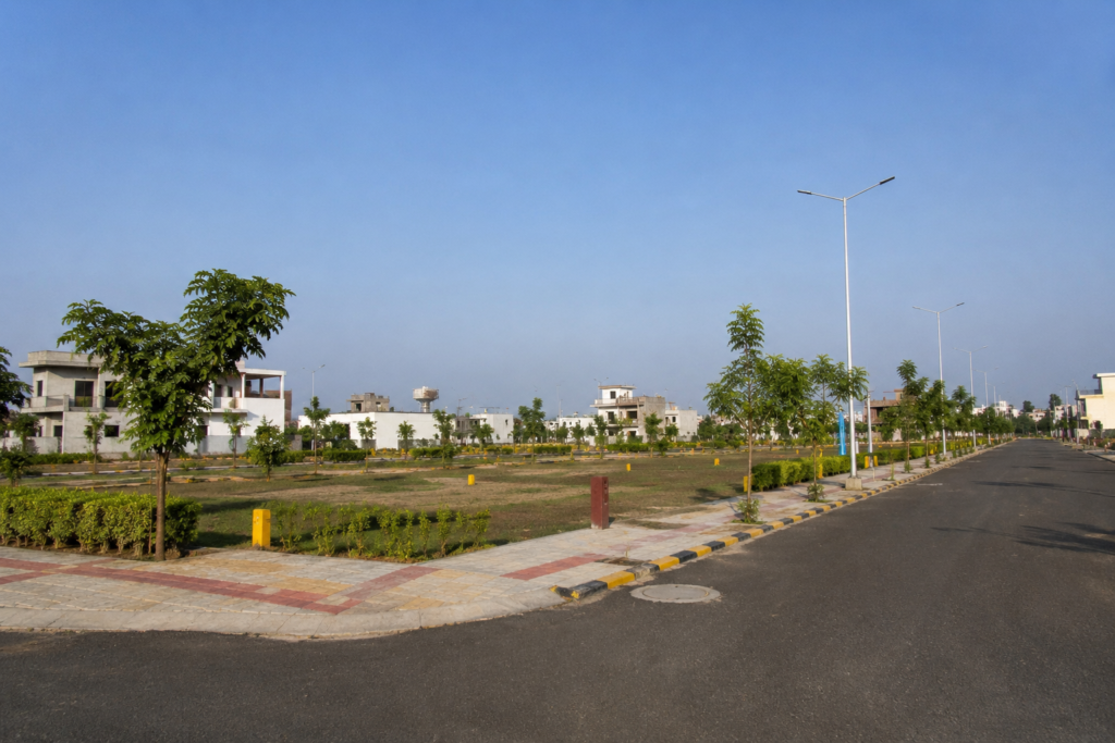 Residential plotted development in Indore with internal roads, greenery and surrounding infrastructure.